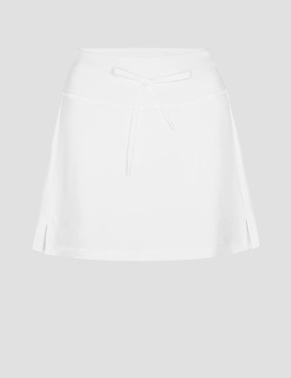 white mini skirt with a drawstring at waistband and built in shorts with pockets.