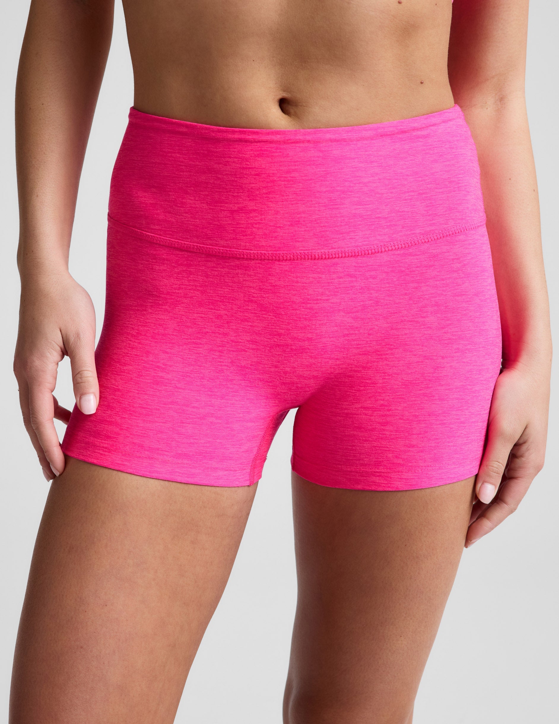 Woman wearing Fuchsia Spacedye™ Keep Pace 3" Mid-Rise Short paired with a sports bra.