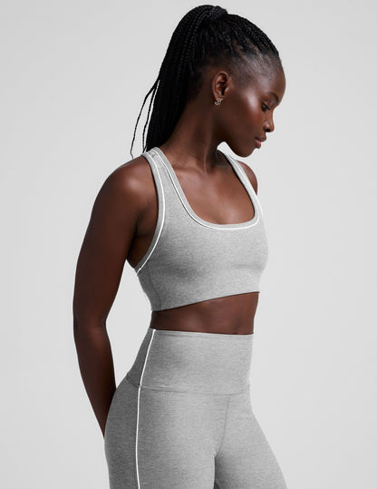 grey scoop neck racerback bra with white contrast trim.