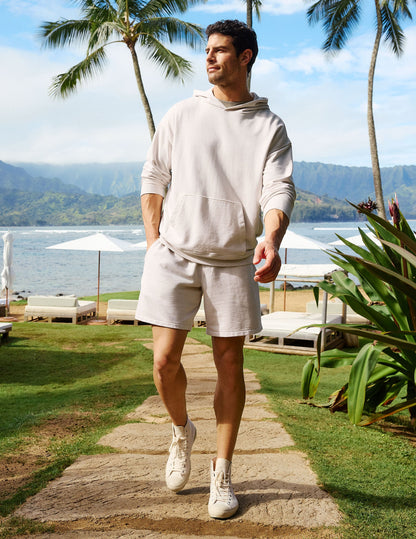 Man wearing Cream Beach Washed Terry Men's Short™ paired with a matching cream hoodie and high-top sneakers.