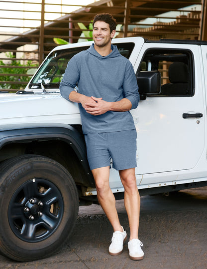 Man wearing Gray Spacedye™ Unlimited Men's Short leaning on a white vehicle, paired with a matching hoodie and sneakers.