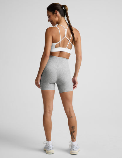 Woman wearing Gray Spacedye™ Streamline 5" Short, rear view, showing V-detail back waistband and white sports bra.
