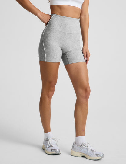 Woman wearing Gray Spacedye™ Streamline 5" Short paired with a white sports bra, featuring a high-rise waistband.