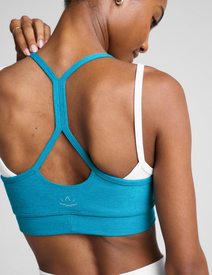 Woman wearing a blue and white layered bra and matching shorts against a plain background.