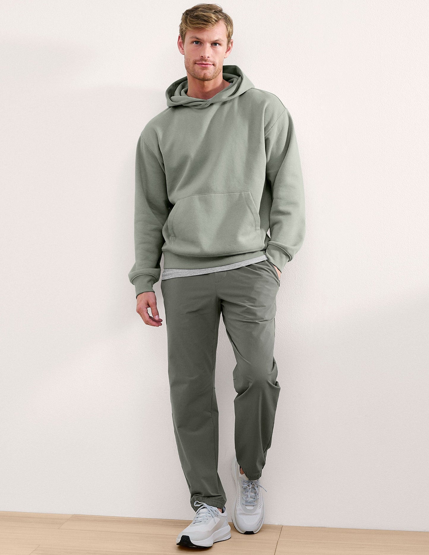 Olive On The Go Men's Jogger on a man, featuring a relaxed fit, cuffed ankles, and elastic waistband in a studio shot.