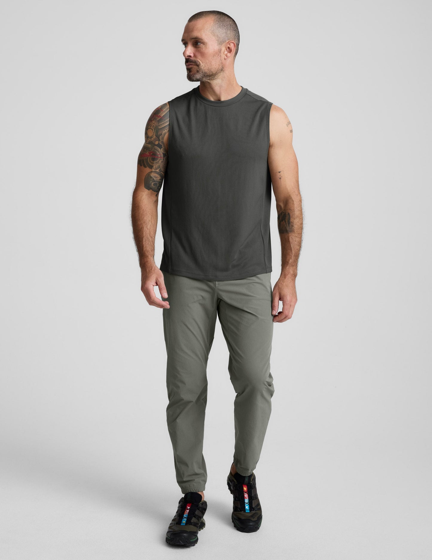 Man wearing olive On The Go Men's Jogger with a relaxed fit and elastic cuffs, standing against a neutral background.