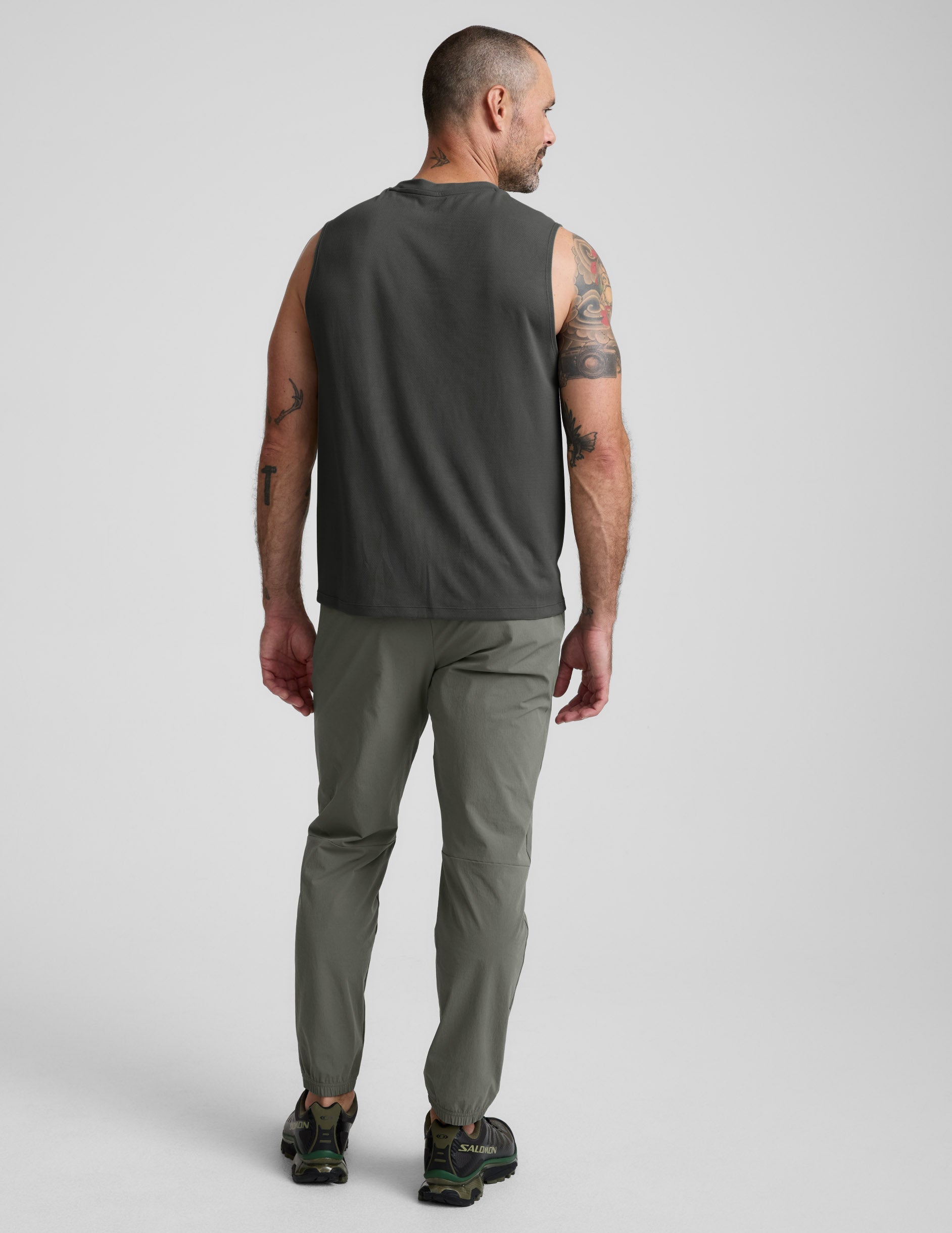 Back view of olive On The Go Men's Jogger showing a relaxed fit, elasticated cuffs, and minimalist style on a male model.