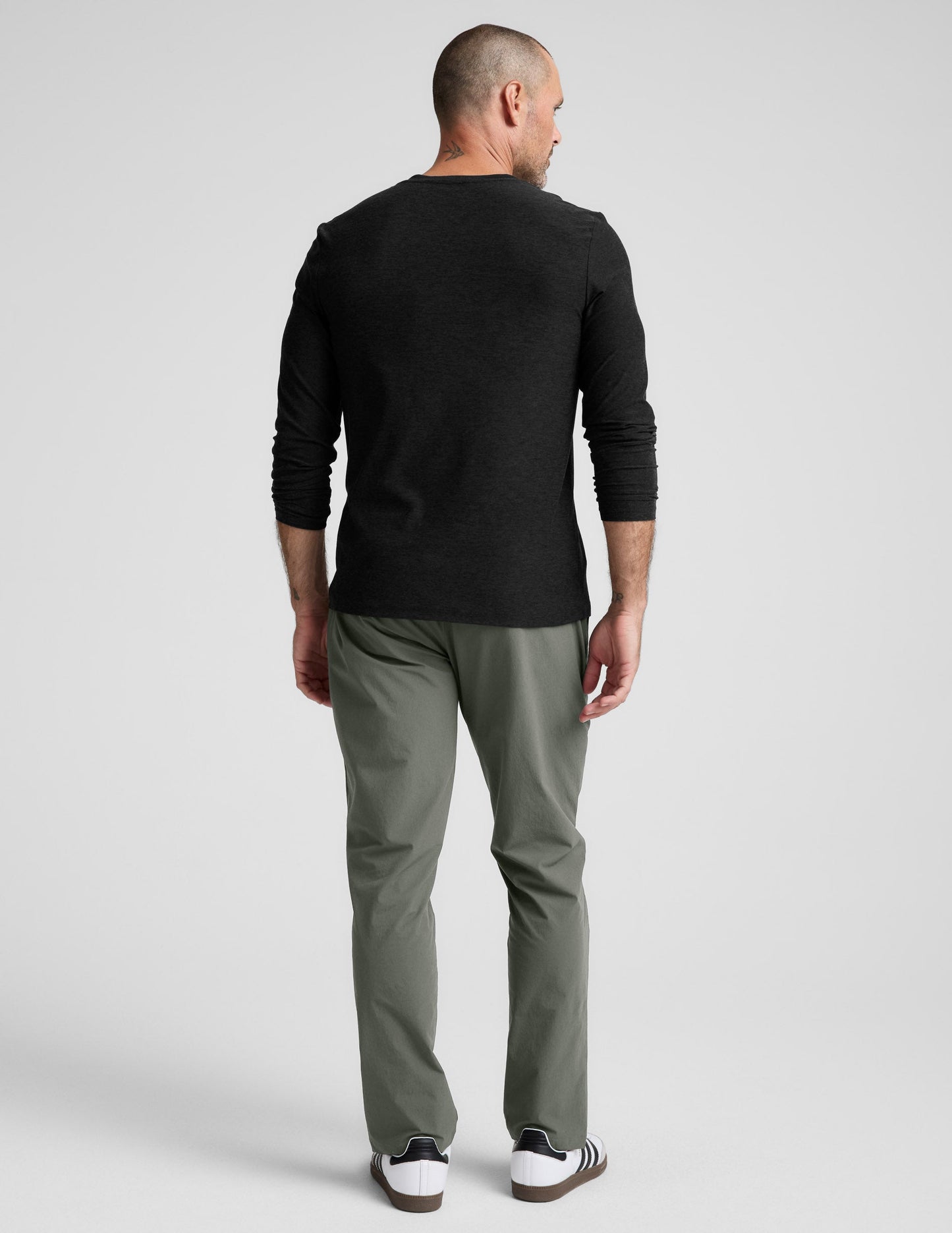 Back view of olive green Men's All Terrain Pant in a regular straight-leg fit, paired with a black long-sleeve shirt.